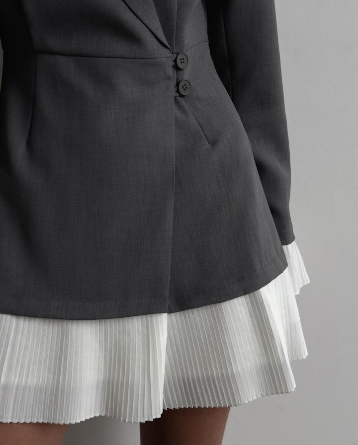 Vestit blazer elegant amb tall ajustat i faldilla plisada estilosa